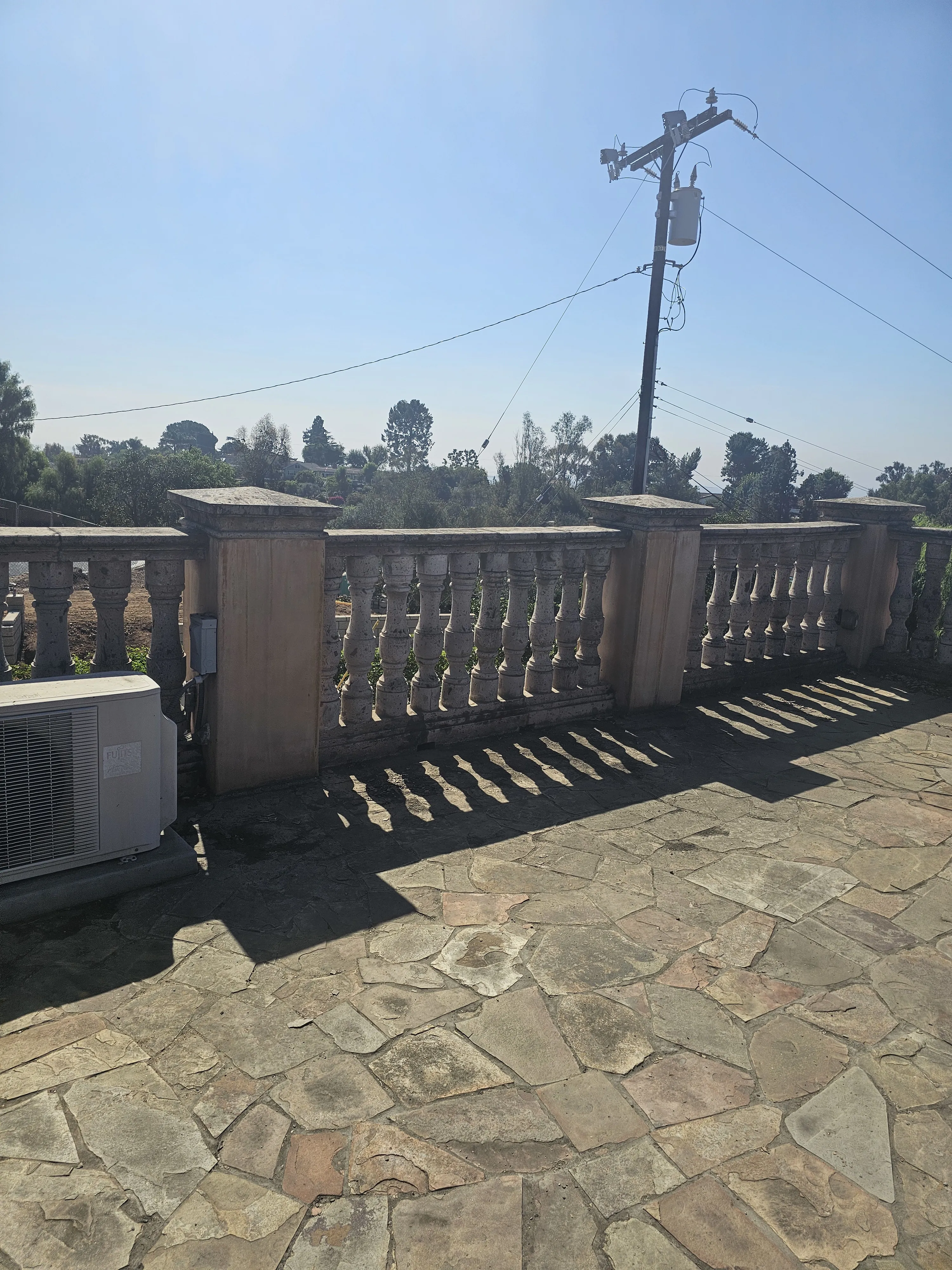 A luxury balcony with a seamless waterproofing finish and a view of the Hollywood Hills