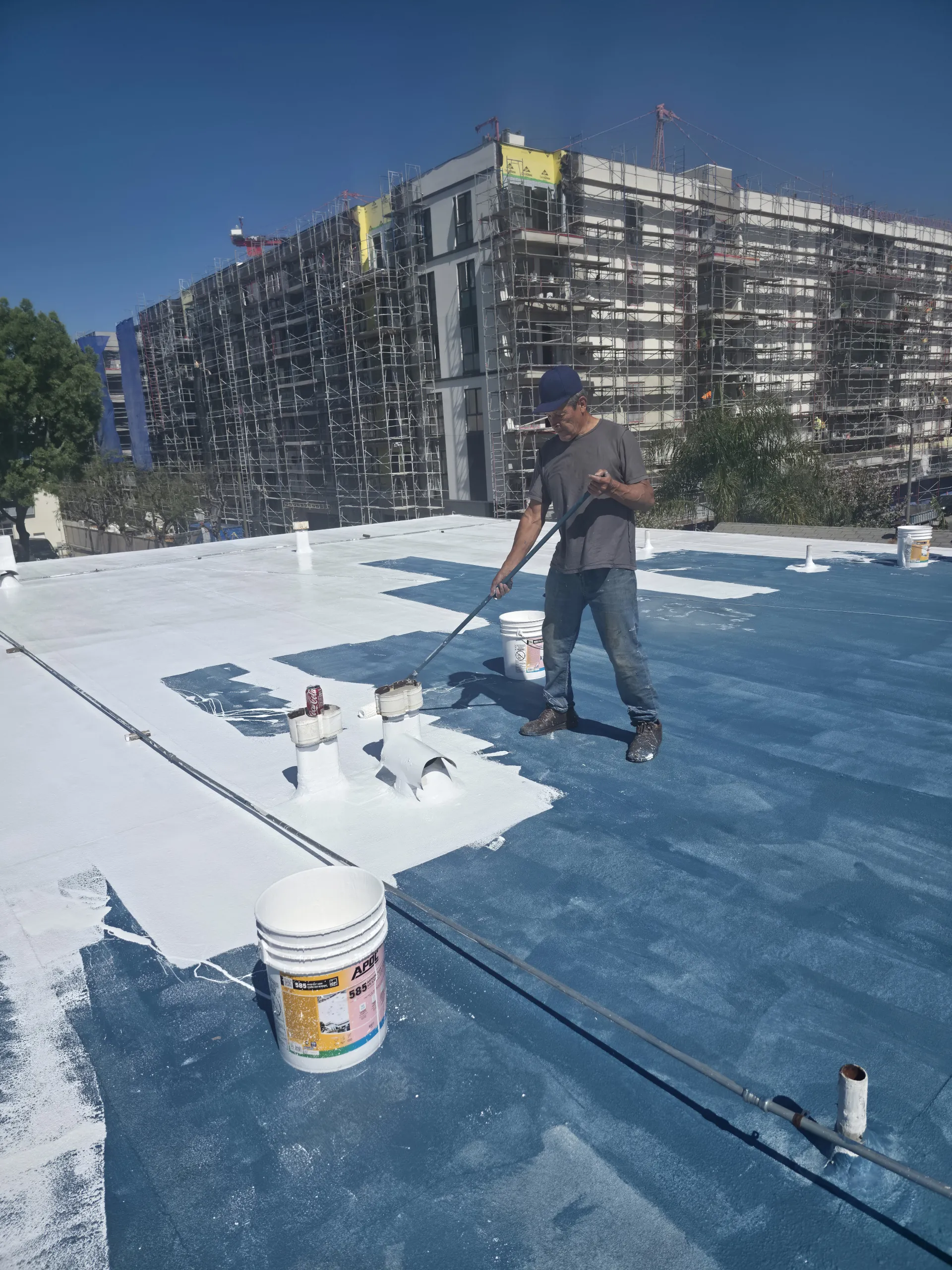 A large commercial building undergoing professional exterior waterproofing in Orange County