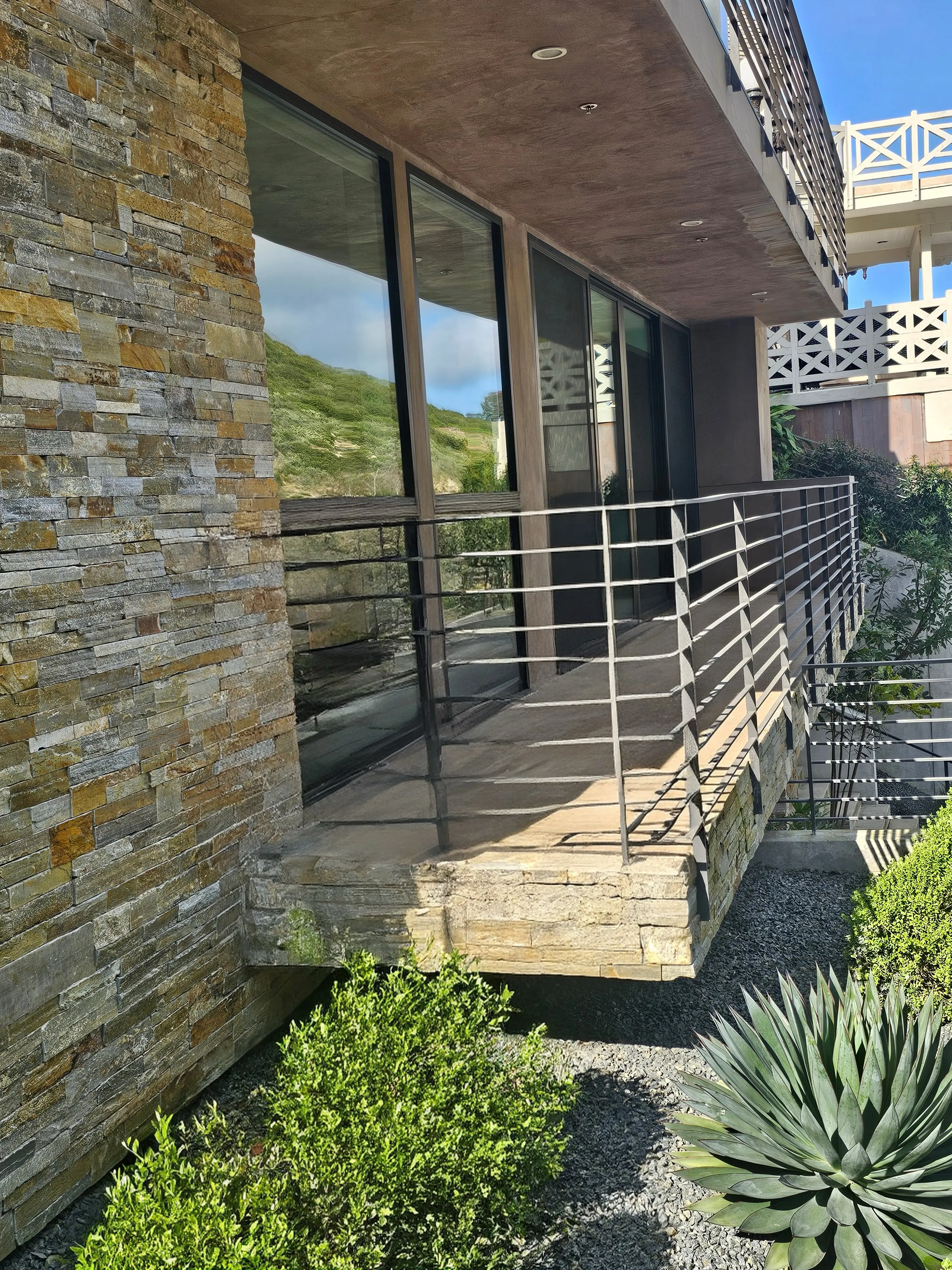 A beautifully waterproofed residential balcony overlooking a coastal landscape