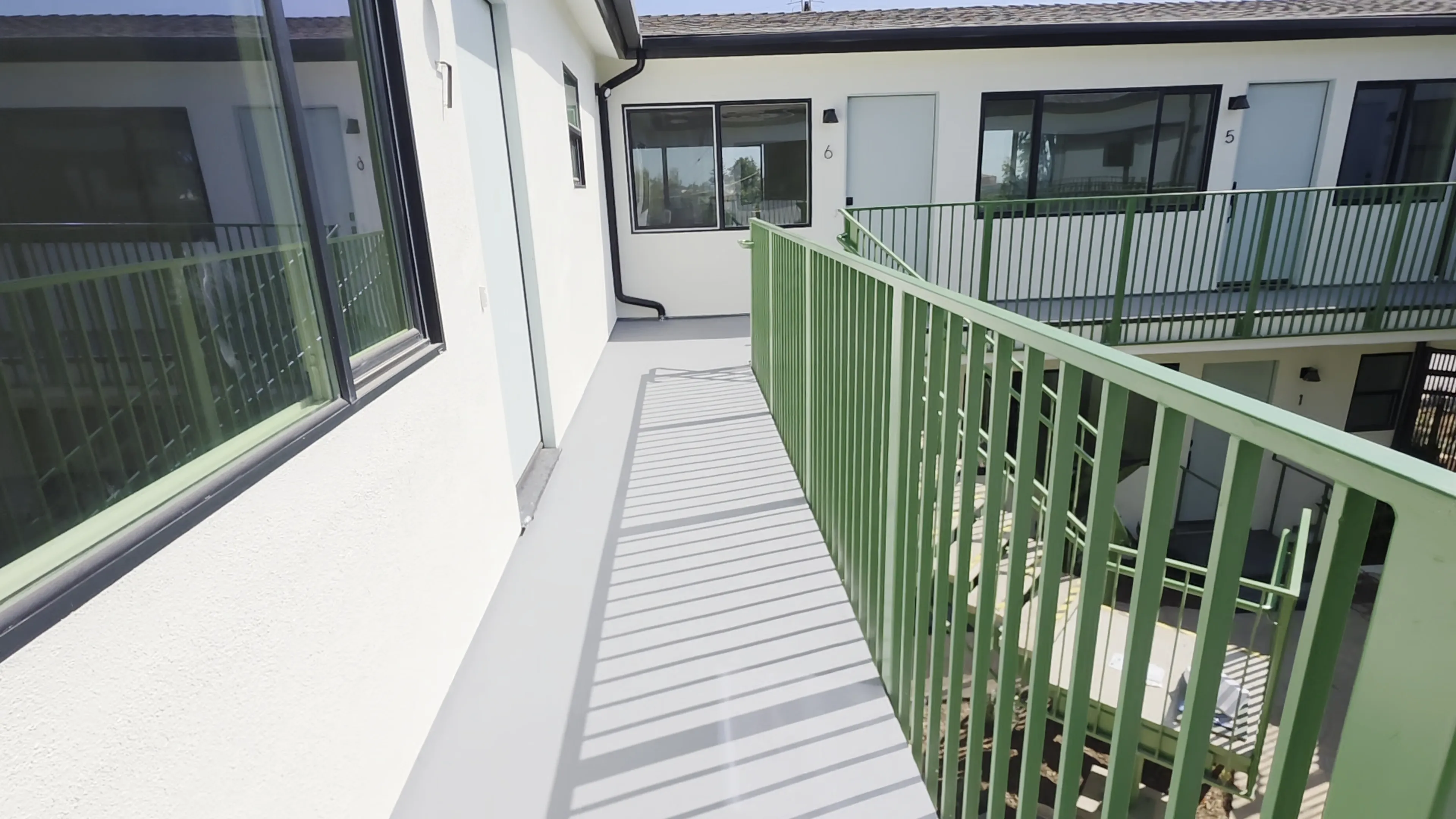 Completed shared second-floor apartment walkway waterproofing project in Pacific Palisades, California.